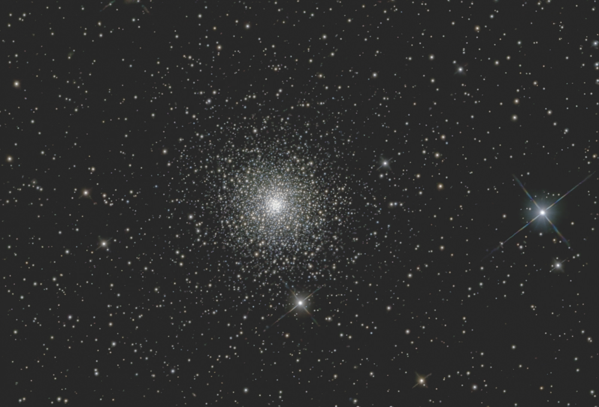 The globular cluster Messier 15 is one of the densest ever discovered, with very hot blue stars and cooler orange stars concentrated toward its bright core. M 15 is located in the constellation Pegasus, 33,600 light-years from Earth.